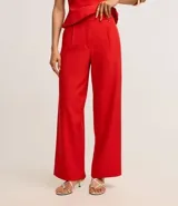 Pantalón de vestir negro de corte wide leg, con cintura alta y doble cintura con detalle de remaches.