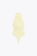 Body blanco de cuello halter drapeado con espalda descubierta y cierre inferior con botones a presión.