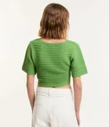 Blusa cropped de punto color verde, con escote cruzado en V y mangas cortas.