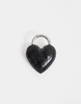 Pin prendedor con forma de corazón negro cubierto de glitter plateado.