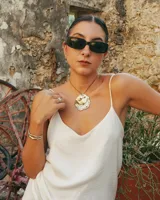 Collar con dije grande de bronce con forma de ostra y cordón de algodón ajustable color gris.