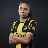Camiseta de fútbol Puma del Club Atlético Peñarol, modelo Home. Diseño a rayas verticales amarillas y negras con detalles en negro en cuello y mangas. Incluye logo de Puma, escudo del club y sponsor Antel en el frente.