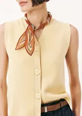 Chaleco de punto color amarillo pálido con cuello en V y cierre frontal con botones.