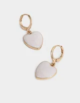 Aros dorados tipo argolla con dije colgante en forma de corazón blanco con diseño marmolado.