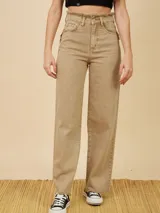 Pantalón jean color beige de pierna ancha, tiro alto y terminación desflecada.