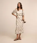 Pollera midi de laise color blanco con bordado de flores y diseño boho.
