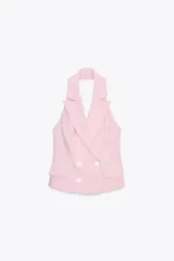 Chaleco rosa con cuello halter y escote pico con solapa. Espalda descubierta. Bolsillos delanteros con solapa. Cierre frontal cruzado con botones.