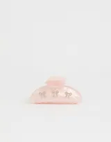 Broche para el pelo color rosa claro con forma de pinza y apliques de strass con forma de moño.