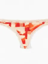 Colaless de microfibra con diseño en tonos naranja y beige y detalles de encaje.