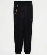 Pantalón jogger negro de poliéster con rayas laterales y cadena decorativa.
