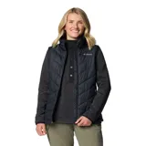 Chaleco acolchado Columbia Heavenly II para mujer, color negro, con forro termorreflectante Omni-Heat™, cuello de felpa forrado de vellón, cierre frontal de dos vías, bolsillos laterales con cremallera y bolsillo interior de seguridad.