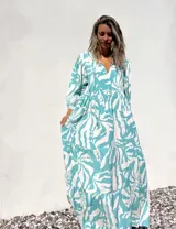 Vestido largo de corte amplio, con estampado abstracto en tonos verde agua y crudo. Tiene escote en V con lazos y mangas largas abullonadas.