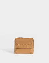 Billetera marrón de cuerina con textura granulada, solapa con broche a presión y apliques de tachas doradas. Cuenta con cierre superior y múltiples compartimentos internos.