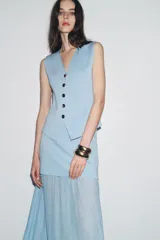 Falda midi celeste con cintura elástica, detalle de tejido combinado plisado y semitransparente.