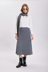Falda midi gris de punto con botones frontales y abertura en el ruedo.