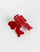 Broche para el pelo rojo con forma de moño.