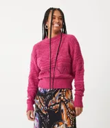 Suéter tejido de punto color fucsia, con cuello redondo y mangas largas. Presenta diseño calado con puntos huecos diferenciados.