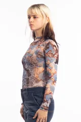 Remera de mangas largas con cuello alto y estampado abstracto en tonos marrones, celestes y grises.