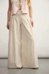Pantalón palazzo a rayas verticales color beige y blanco, de tiro alto y corte amplio.
