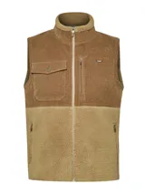 Chaleco beige con diseño de mitad sherpa y mitad cotelé, cuello alto y cierre frontal con cremallera. Incluye tres bolsillos con cremallera y un bolsillo con botón.