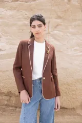 Blazer color chocolate de lino con solapas con borde en contraste color beige, cierre con un botón y corte entallado.