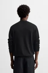 Jersey negro de lana y cashmere, de corte regular, cuello redondo y manga larga.