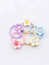 Pack de cinco gomitas de pelo con adorno de flor de plástico en colores pastel: rosa, celeste, lila, amarillo y blanco.