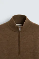 Jersey azul marino de punto, corte regular, cuello alto con cremallera, manga larga y terminaciones en rib.
