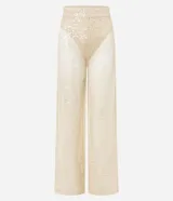 Pantalón femenino estilo pantalona de corte amplio, color beige claro, con superposición de lentejuelas y forro interior tipo bombacha cavada.
