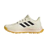 Championes Adidas para hockey sobre hierba, modelo Hockey Youngstar. Color crema con detalles en negro y suela color caramelo.