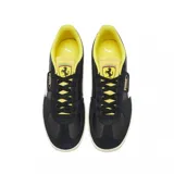 Championes Puma Palermo negros con detalles en amarillo y blanco. Presentan una suela de goma color crema y el logo de Puma en dorado en el lateral.