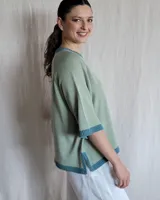 Sweater color beige de tejido de punto con mangas cortas y cuello redondo.