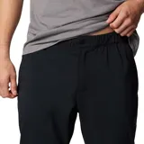 Pantalón de trekking negro con corte tapered, tejido resistente al agua y a las manchas, cintura elástica, bolsillos delanteros, bolsillo de seguridad, dobladillo elástico, entrepierna reforzada, pierna acampanada y bolsillo trasero con botón de presión.