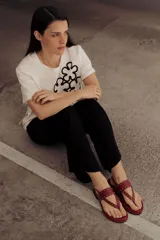 Sandalias marrones de cuero con tiras, microtachas doradas y hebilla lateral.