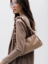 Blazer color marrón claro, sin cierre frontal, de mangas largas y solapas de traje.