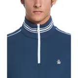 Buzo deportivo azul con cuello alto con cierre 1/4, mangas largas y bolsillos laterales con ribete blanco. Tiene puños acanalados con rayas blancas y logo bordado en el pecho.