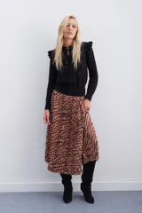 Falda midi plisada con estampado animal print de cebra en tonos beige y marrón. Tiene cintura elástica.