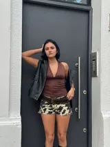 Short de jean con estampado animal print de vaca en blanco y negro, tiro alto, corte ajustado y ruedo desflecado.