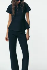 Pantalón de punto azul marino, de tiro alto, corte ajustado y bota acampanada.