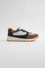 Zapatillas urbanas con exterior de cuero sintético color marrón, blanco y azul marino. Cordones blancos y suela de goma color caramelo.