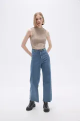 Chaleco verde pálido de punto con cuello alto y diseño trenzado.