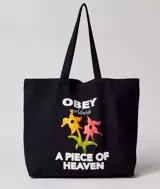 Bolso tote negro de algodón con asas largas. Estampado frontal con el logo de Obey, flores y la frase "A Piece of Heaven".