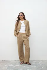 Pantalón caqui de corte recto y tiro alto, con bolsillos laterales y pinzas en la cintura.