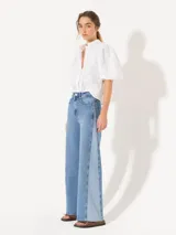 Jeans Mary Sun wide leg de calce recto, confeccionado en denim azul con lycra. Presenta tiro alto, bolsillos delanteros y traseros, y terminación con ruedo desflecado.