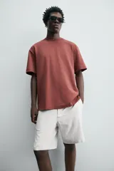Camiseta blanca de algodón interlock con elasticidad, corte recto, cuello redondo y mangas cortas.