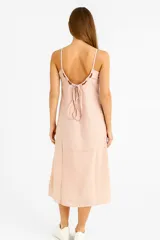 Vestido midi color rosa pálido, de corte recto y breteles finos con detalle metálico.