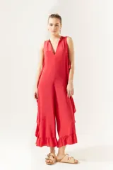 Mono enterito de viscosa color rojo coral, con escote en V, sin mangas y corte a la pantorrilla. Presenta volados en los laterales y en el ruedo.