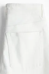 Pantalón de jean blanco de tiro alto, corte recto y cinco bolsillos.