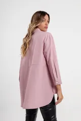 Camisa de color crudo con corte largo y botón frontal, ideal para combinación con jeans.