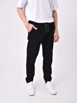 Pantalón jogger negro con cintura elástica ajustable con cordón y tobillos ajustados.